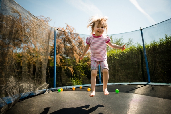 Young child jumping on a trampoline