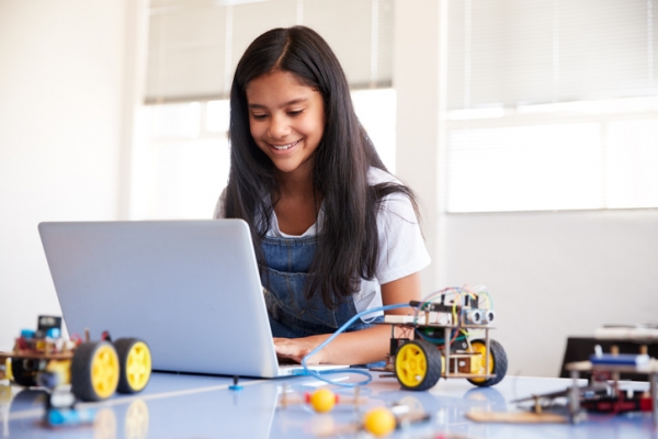 Girl programming robot vehicle