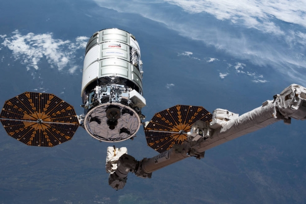 Cygnus spacecraft being held by Canadarm