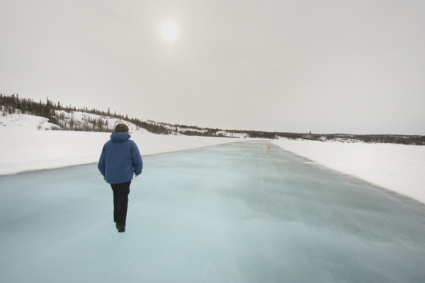 Woman walking on ice road