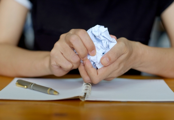 Student crumpling a piece of paper