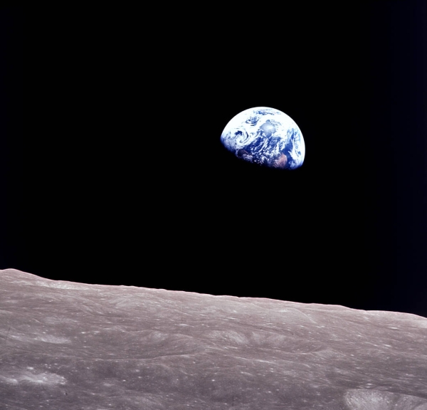 The Earth rising over the Moon's horizon