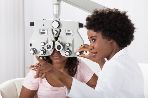 Optometrist performing an eye test on a child. 
