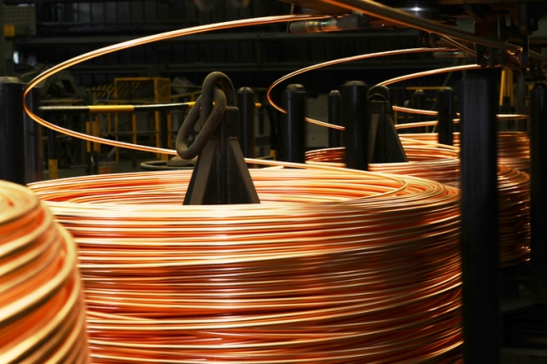 Shown is a colour photograph of four large rolls of thick metal wire.