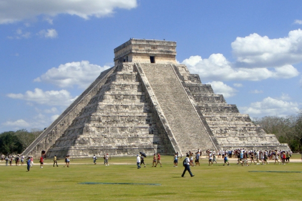 The El Castillo Pyramid Temple with tourists in the foreground