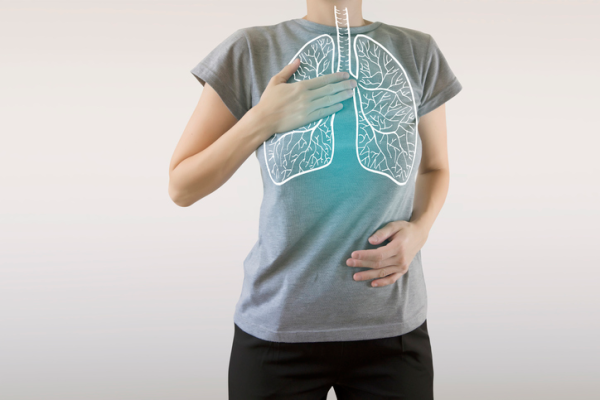 Shown is a colour photograph of a person overlaid with an illustration of lungs.
