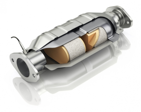 Shown is a colour illustration of a catalytic converter, cut to reveal the materials inside.