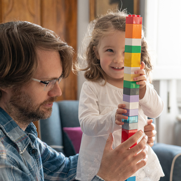 Child and parent stacking blocks